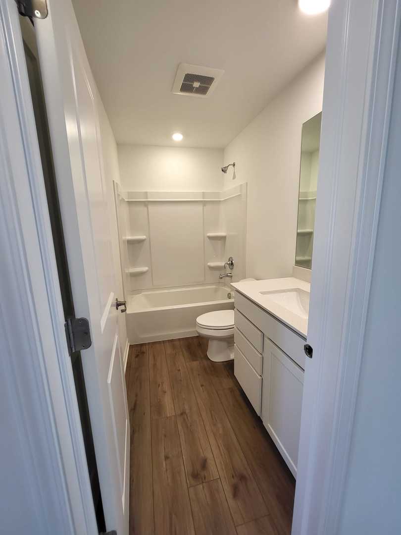 630 Wolverine Drive Aurora, IL 60502 - Photo 17 of 21 a bathroom with a sink a toilet and shower