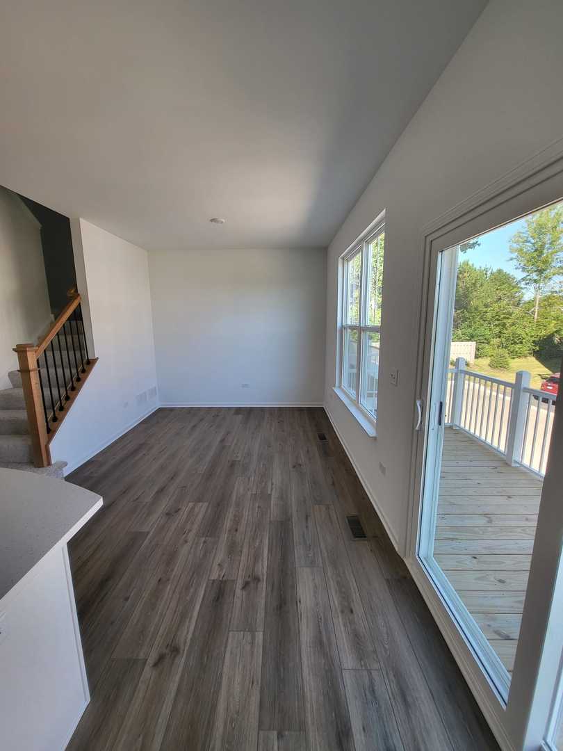 630 Wolverine Drive Aurora, IL 60502 - Photo 5 of 21 a view of an empty room with wooden floor and a window