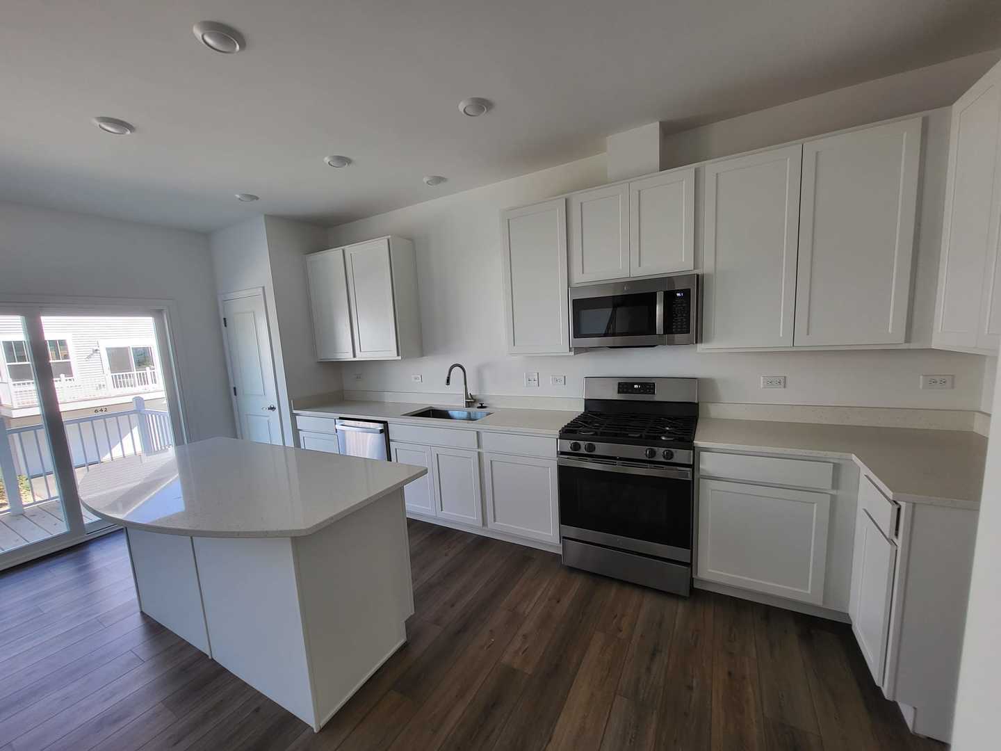 630 Wolverine Drive Aurora, IL 60502 - Photo 8 of 21 a kitchen with stainless steel appliances granite countertop white cabinets a stove a sink and a wooden floor