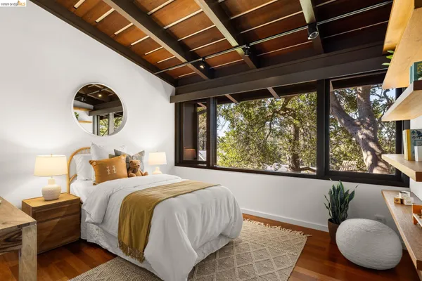 a bedroom with bed and a large window