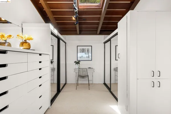 a bathroom with a sink double vanity granite tub shower and mirror