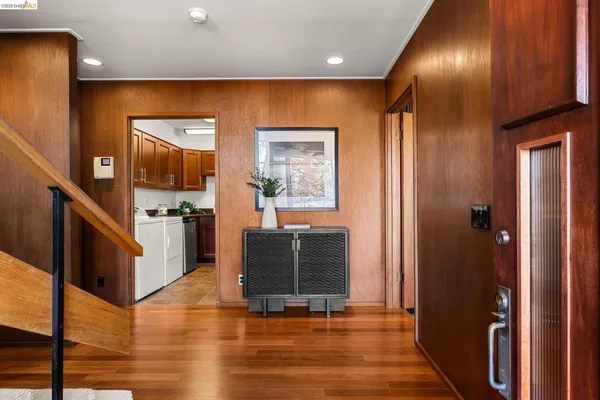 a view of entryway with wooden floor and stairs