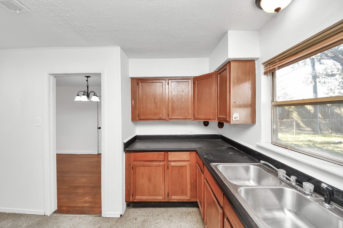 201 Delta Street Pasadena, TX 77506 - Photo 17 of 33 a kitchen with a sink and large window