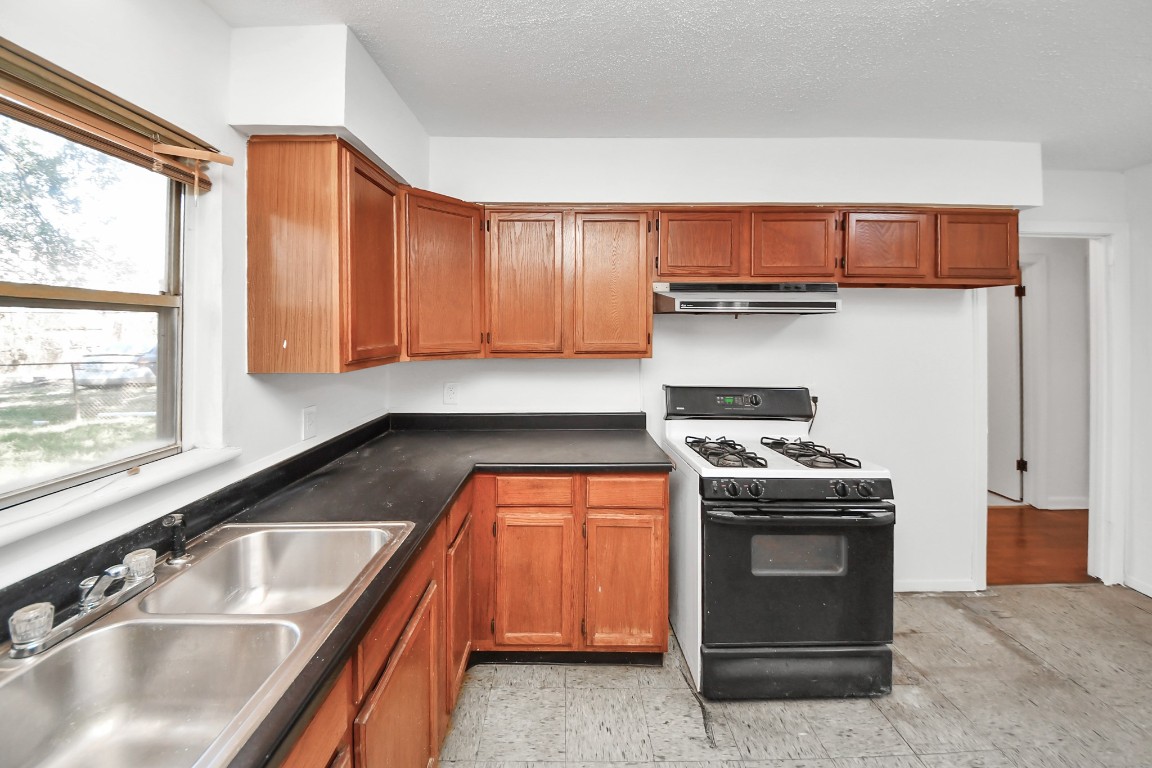 201 Delta Street Pasadena, TX 77506 - Photo 18 of 33 a kitchen with stainless steel appliances granite countertop a sink and a stove