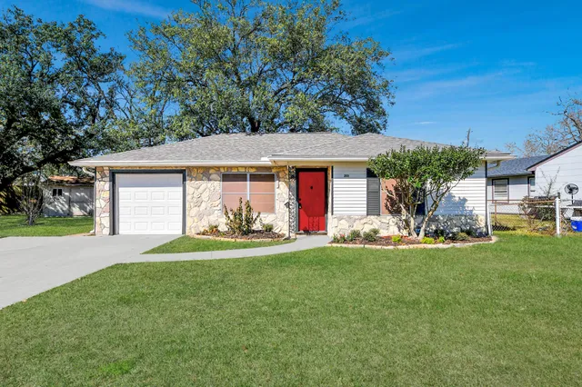 a front view of a house with a garden and porch