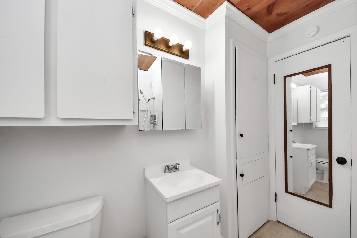 201 Delta Street Pasadena, TX 77506 - Photo 22 of 33 a bathroom with a sink toilet and mirror