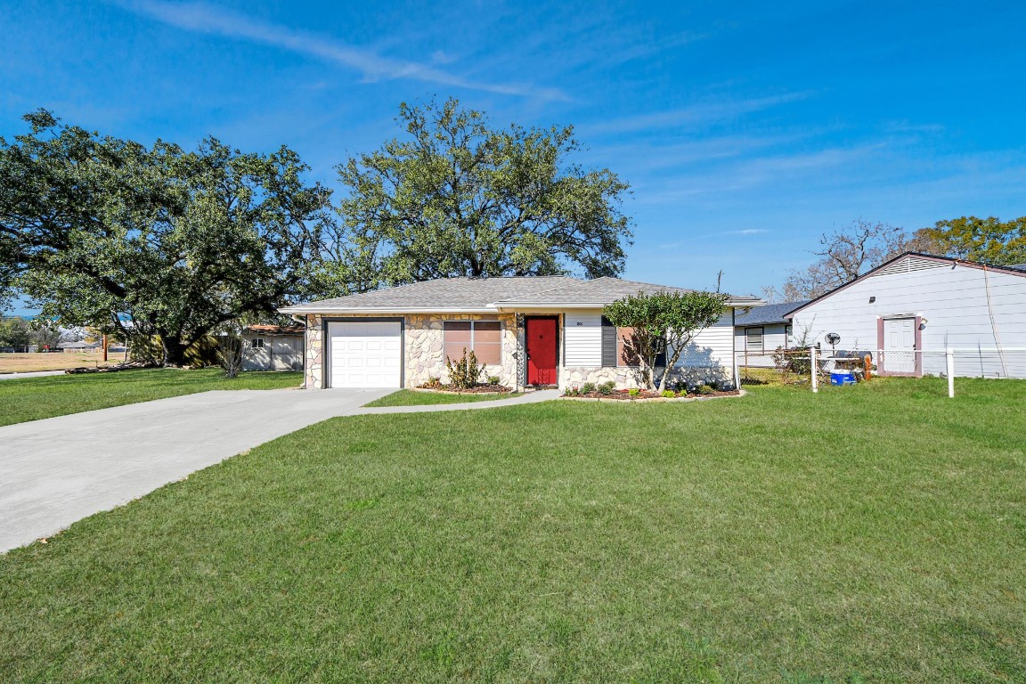 201 Delta Street Pasadena, TX 77506 - Photo 3 of 33 a view of a white house with a big yard and large trees