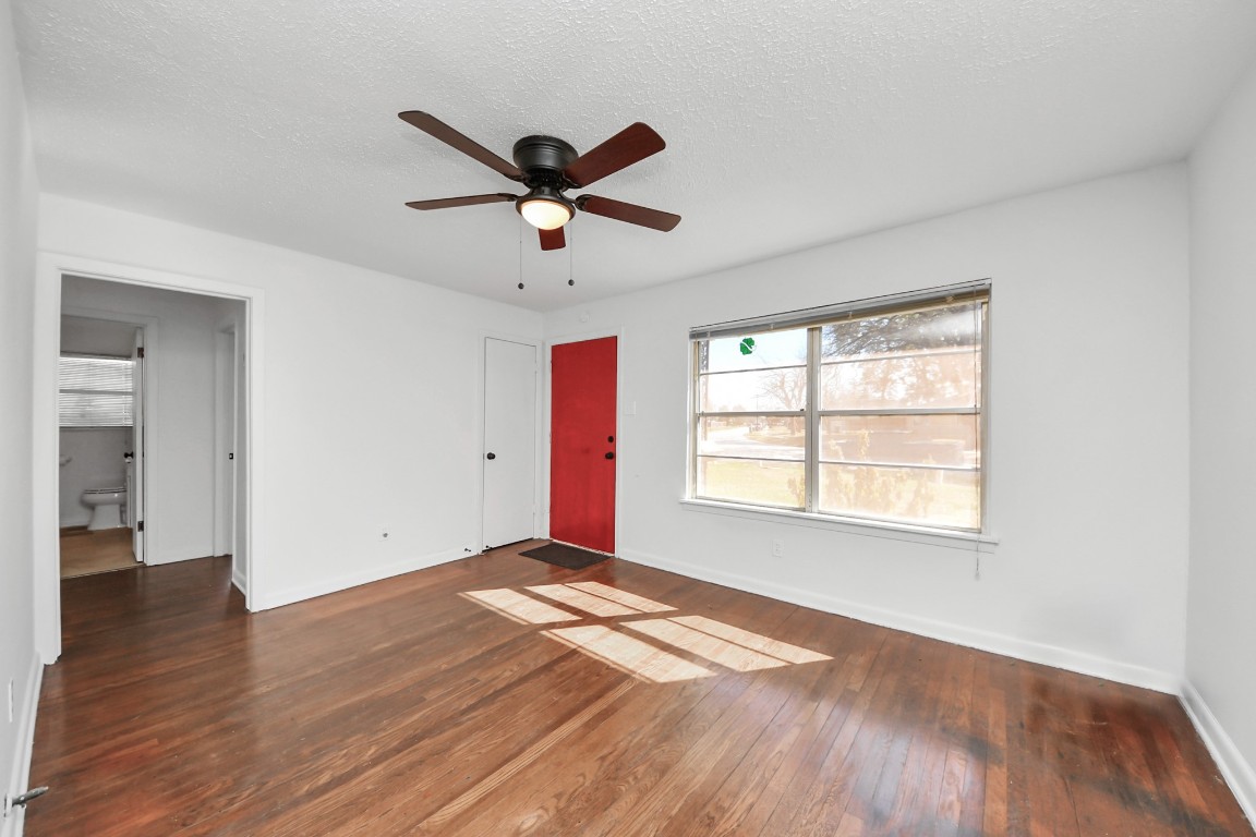 201 Delta Street Pasadena, TX 77506 - Photo 8 of 33 a view of empty room with wooden floor and fan