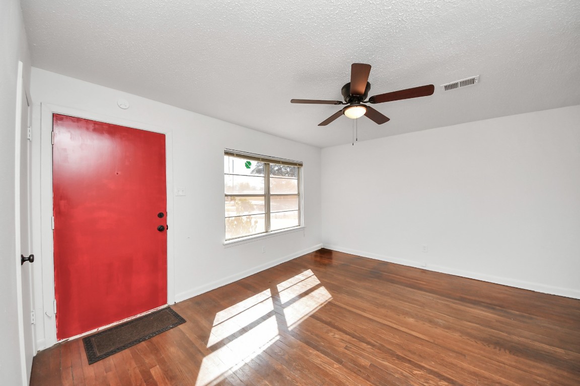 201 Delta Street Pasadena, TX 77506 - Photo 9 of 33 a view of empty room with wooden floor and fan
