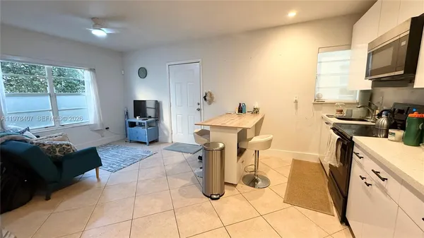 a kitchen with stainless steel appliances kitchen island granite countertop a sink and cabinets