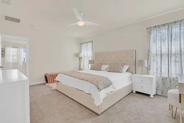 a bed room with a bed and a chair