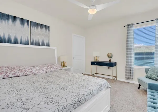 a bedroom with a bed and a couch