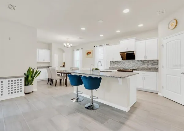 a kitchen with a counter space a sink appliances and cabinets