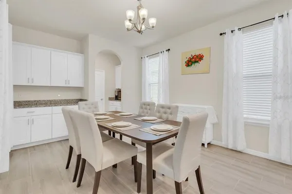 a view of a dining room with furniture and wooden floor