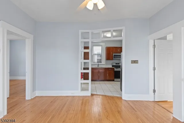 a view of a kitchen with wooden floor and a sink