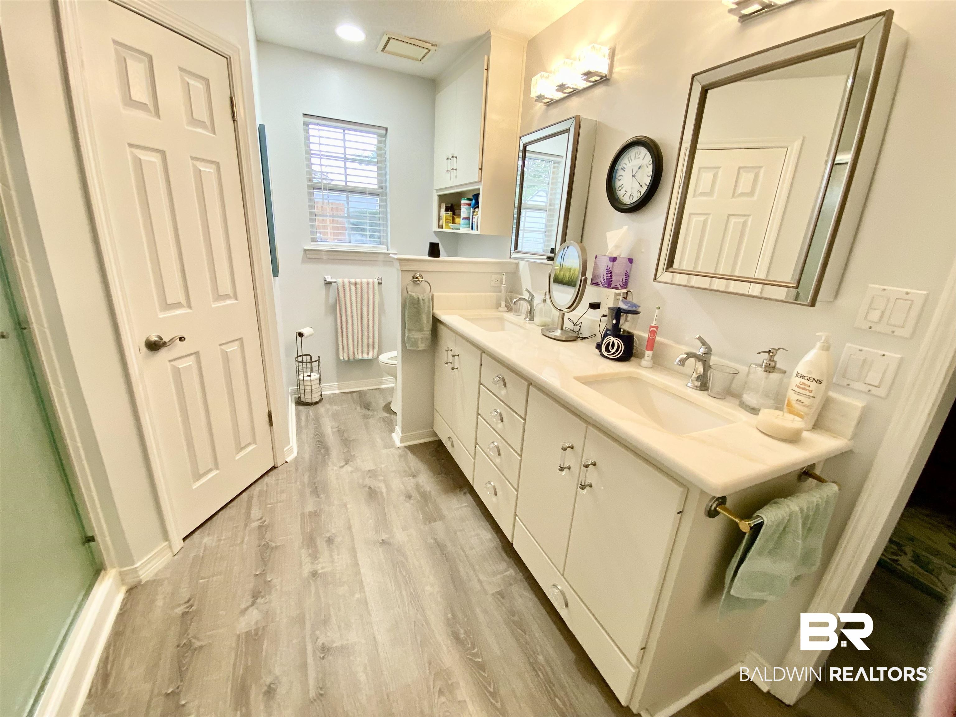 2872 Avenida Alberto Lillian, AL 36549 - Photo 19 of 31 Bathroom with hardwood / wood-style floors, vanity, and toilet