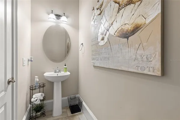 a living room with furniture and a view of kitchen