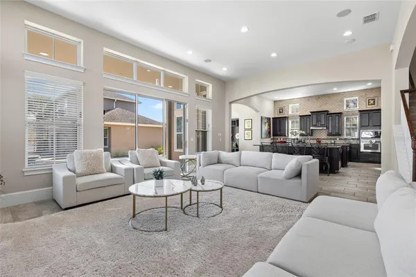 a living room with furniture and large windows
