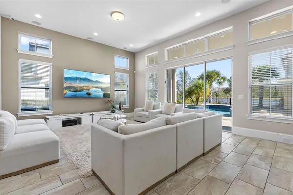 a kitchen with stainless steel appliances a table chairs refrigerator and a sink