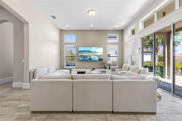 a kitchen with stainless steel appliances a refrigerator a stove a sink dishwasher with a dining table and chairs