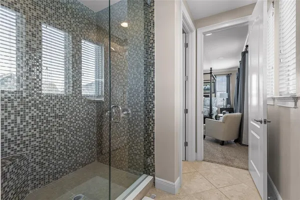 a spacious bathroom with a tub shower and mirror