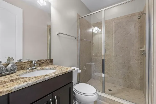 a bathroom with a shower and a toilet