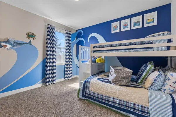 a bedroom with two beds and a window