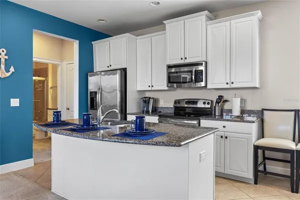 a bathroom with a granite countertop sink a toilet and shower