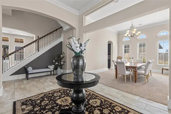 a view of a dining room with furniture and a chandelier