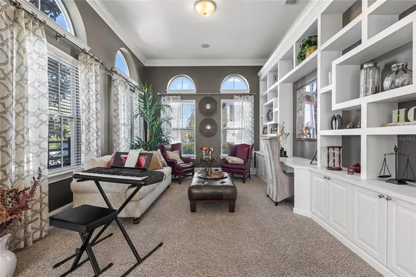 a living room filled with furniture and a floor to ceiling window