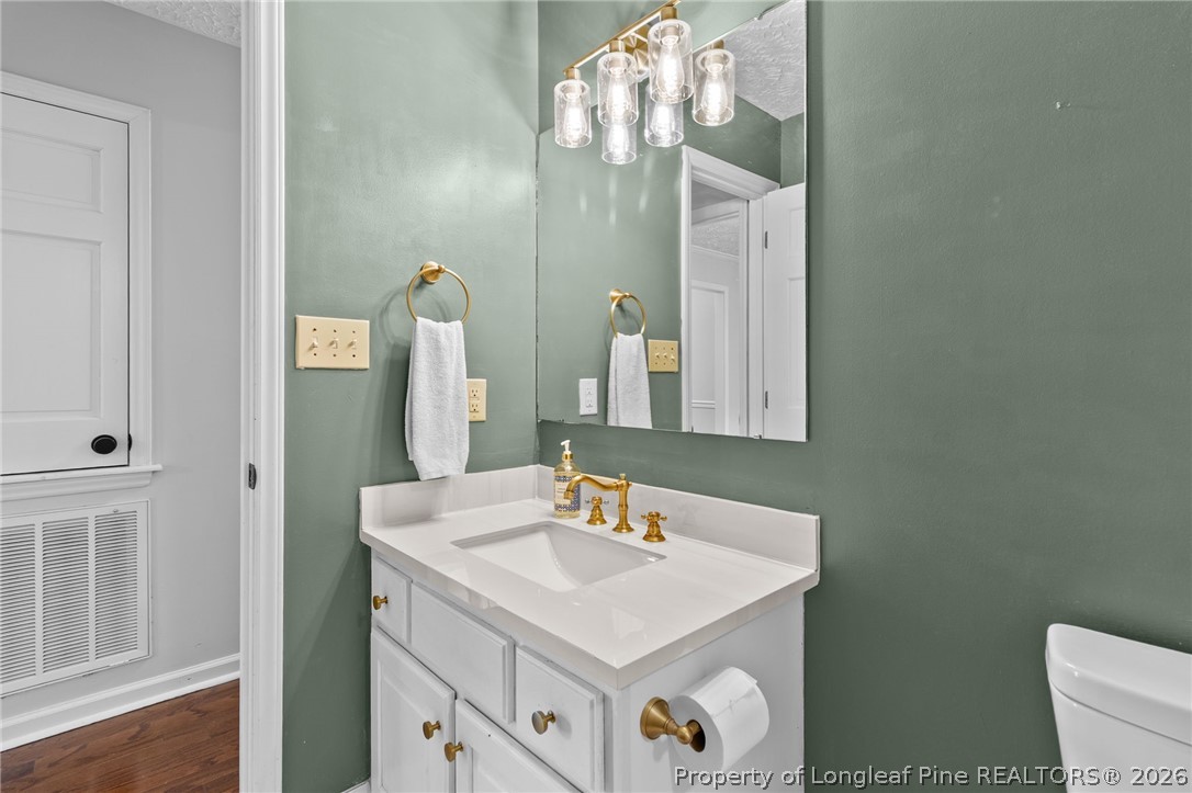 7756 Dragonhead Road Fayetteville, NC 28311 - Photo 31 of 42 a bathroom with a sink vanity and a mirror