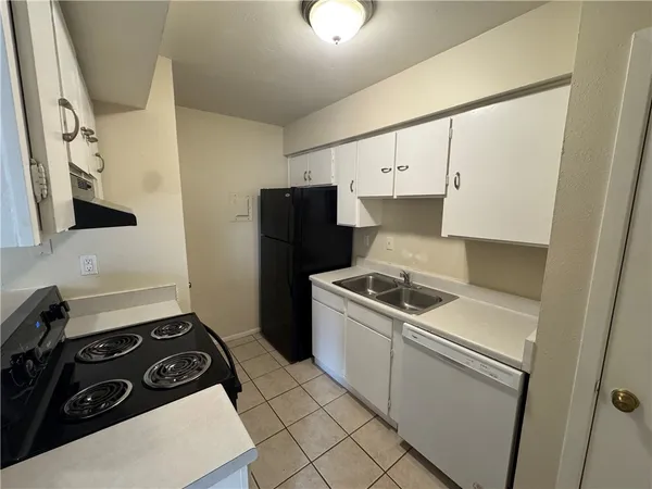 a kitchen with a stove and a refrigerator