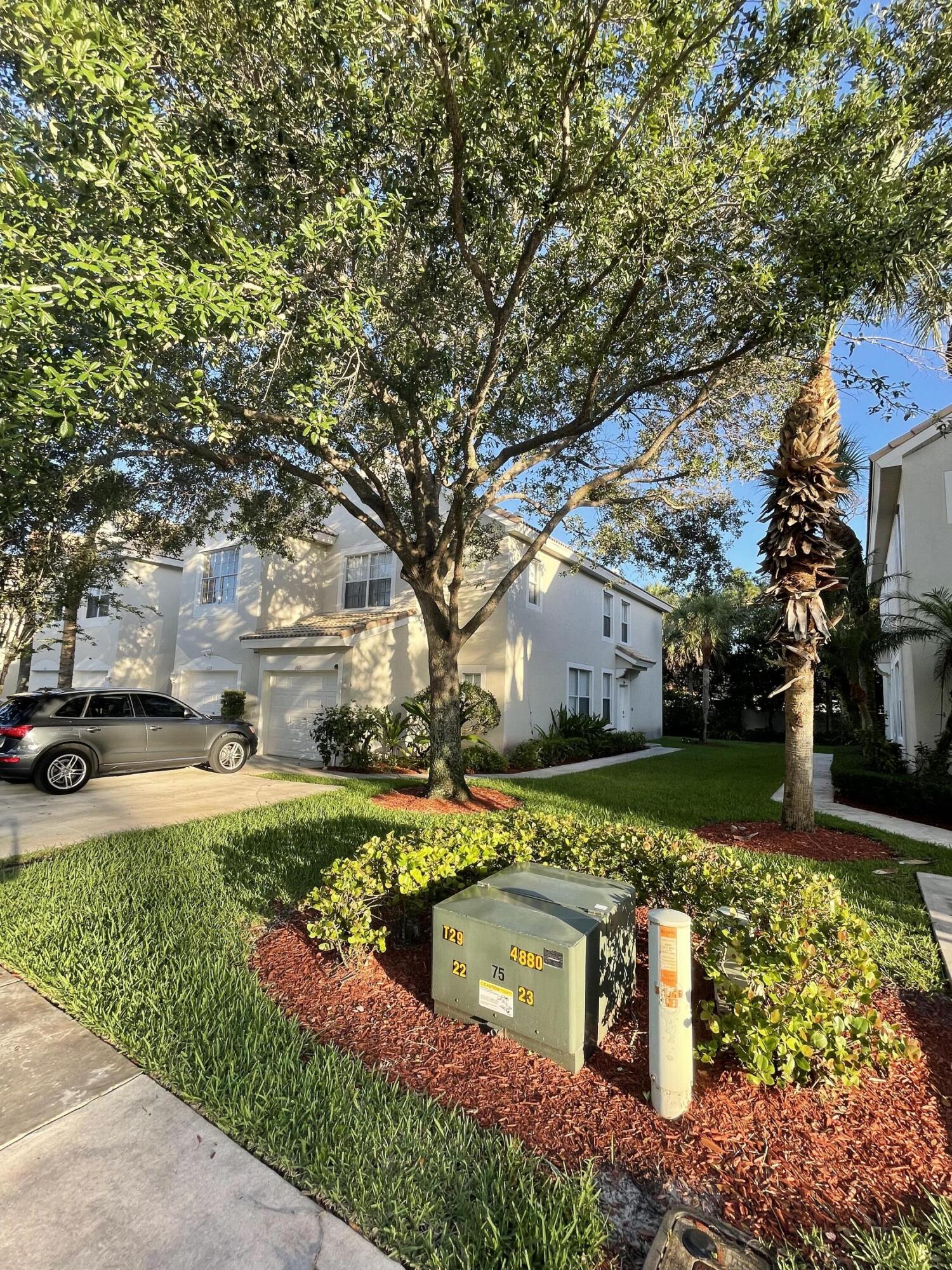 1021 Woodfield Road Greenacres, FL 33415 - Photo 4 of 32 FRONT SIDE VIEW