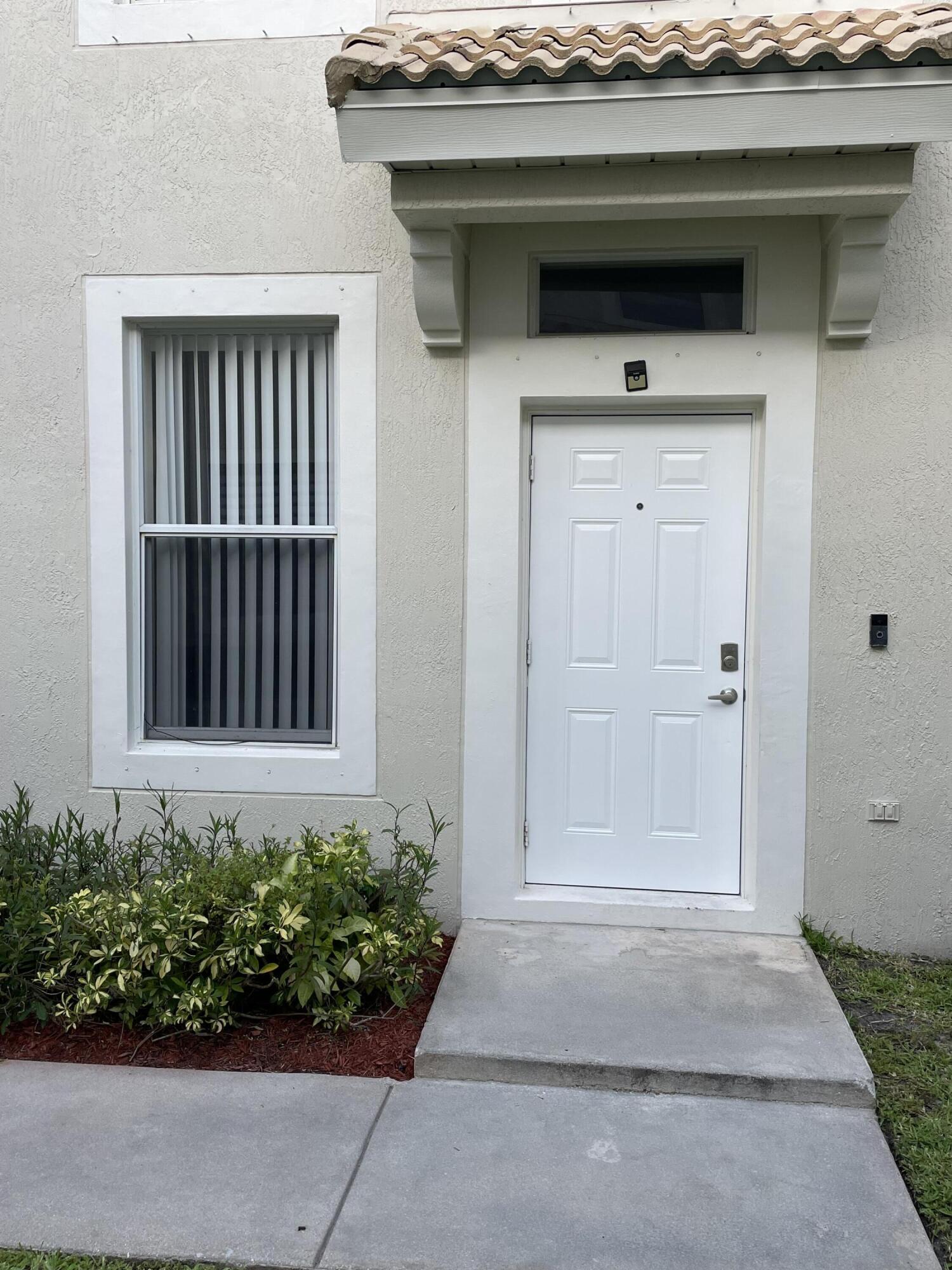 1021 Woodfield Road Greenacres, FL 33415 - Photo 5 of 32 FRONT ANTRANCE