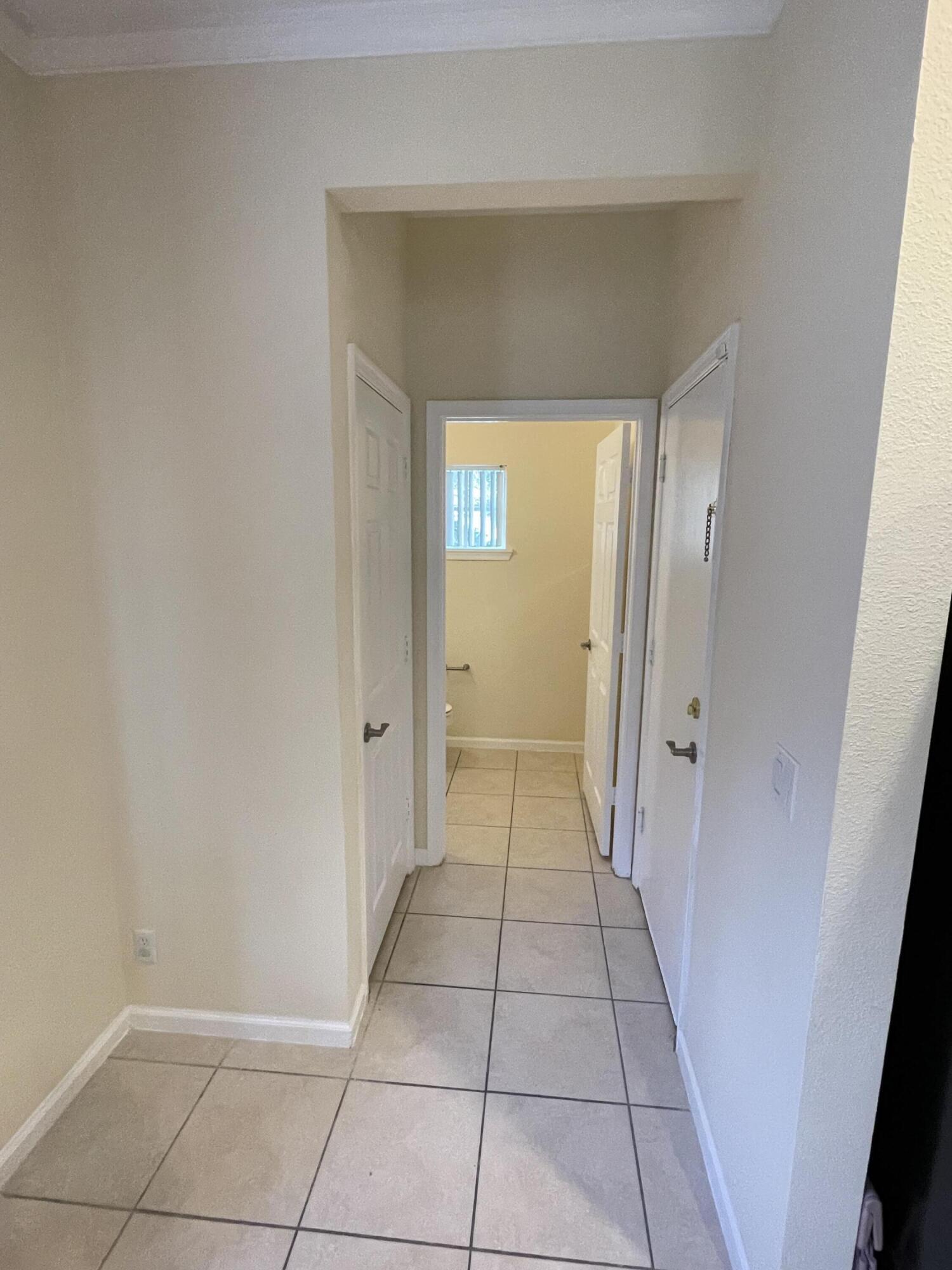 1021 Woodfield Road Greenacres, FL 33415 - Photo 9 of 32 GARAGE AND HALF BATH HALL WAY