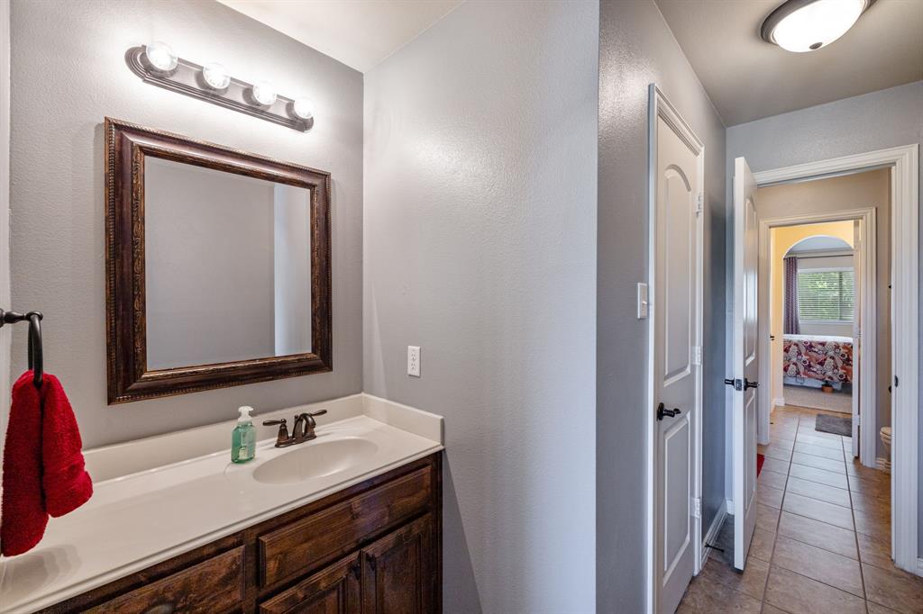 8104 Red Riv Run North Richland Hills, TX 76180 - Photo 23 of 38 a bathroom with a sink and a mirror