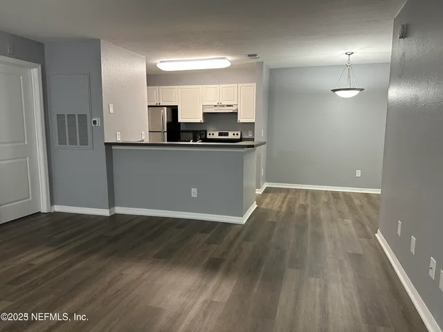 a kitchen with stainless steel appliances a refrigerator a stove and a sink