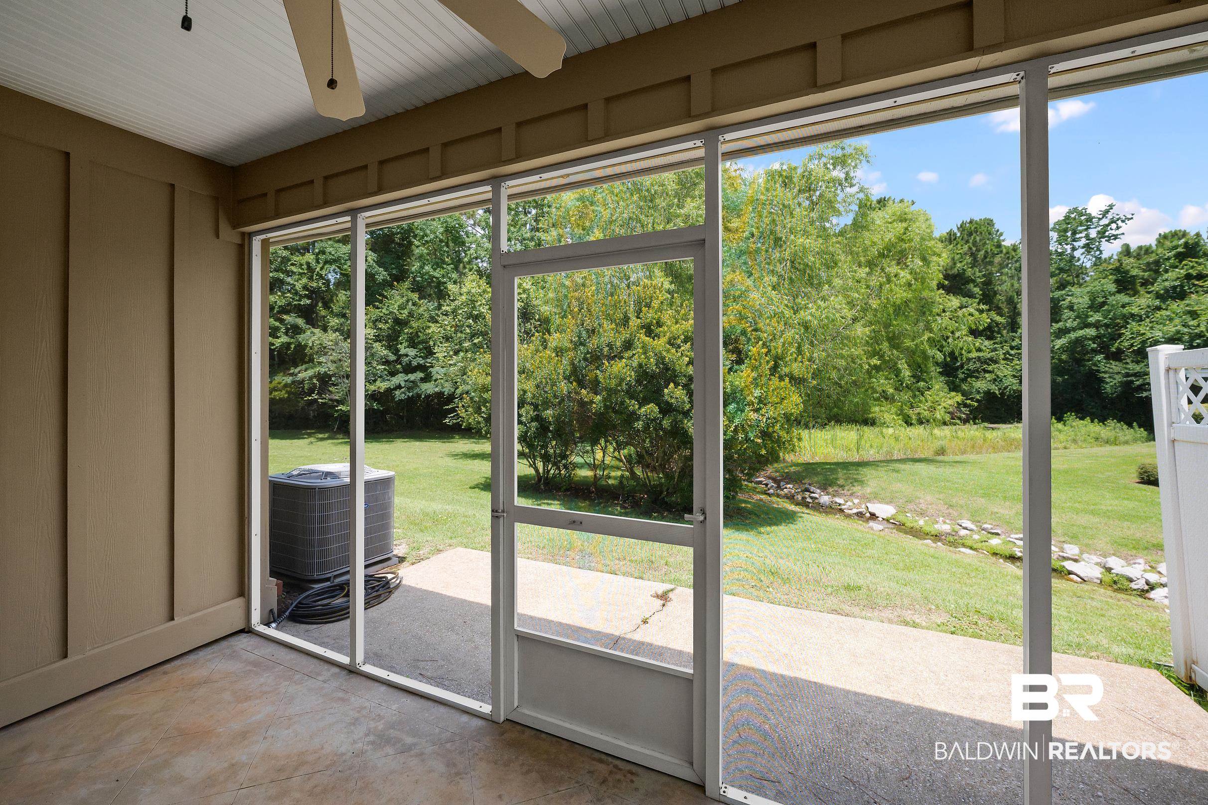 430 West Fort Morgan Road, Unit 704 Gulf Shores, AL 36542 - Photo 26 of 35 Screened patio with a concrete floor, beadboard ceiling, and ceiling fan
