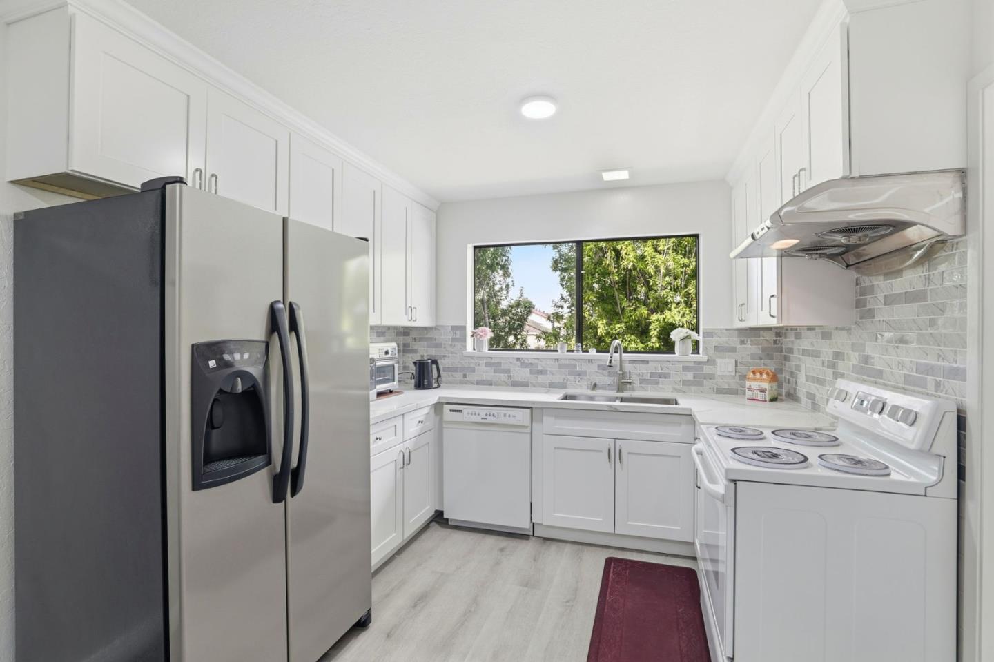 4013 Ralston Common Fremont, CA 94538 - Photo 11 of 40 a kitchen with a sink a refrigerator and window