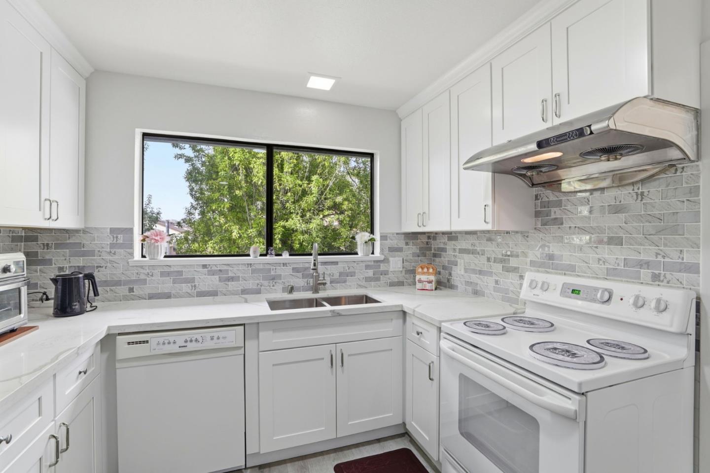 4013 Ralston Common Fremont, CA 94538 - Photo 12 of 40 a kitchen with cabinets appliances a sink and a window