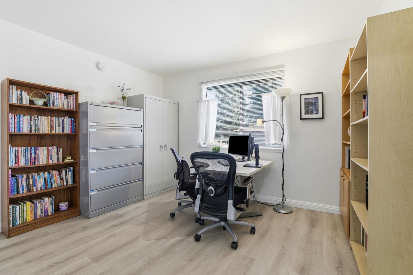 4013 Ralston Common Fremont, CA 94538 - Photo 18 of 40 a view of a workspace with furniture and a bookshelf