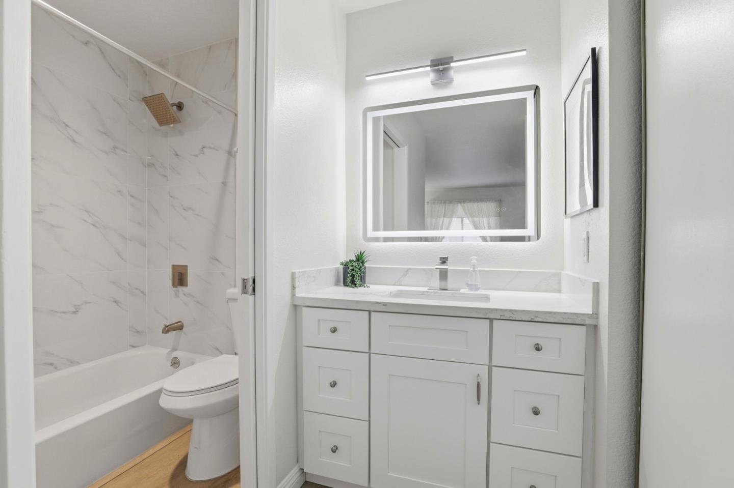 4013 Ralston Common Fremont, CA 94538 - Photo 23 of 40 a bathroom with a granite countertop toilet a sink and a bathtub