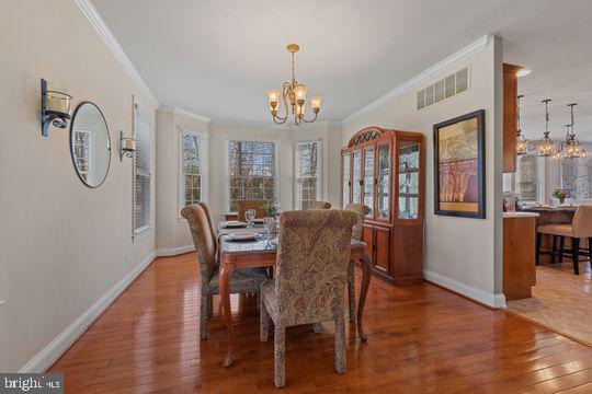 784 Olivia Way Pasadena, MD 21122 - Photo 14 of 38 a view of a dining room with furniture window and wooden floor