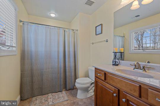784 Olivia Way Pasadena, MD 21122 - Photo 17 of 38 a bathroom with a toilet a sink and a mirror