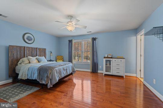 784 Olivia Way Pasadena, MD 21122 - Photo 19 of 38 a bedroom with a bed and wooden floor