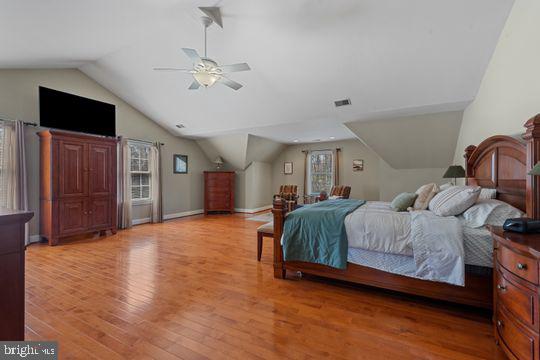 784 Olivia Way Pasadena, MD 21122 - Photo 21 of 38 a spacious bedroom with a large bed and wooden floor