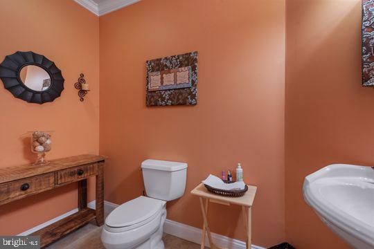 784 Olivia Way Pasadena, MD 21122 - Photo 31 of 38 a white toilet sitting next to a bathroom sink