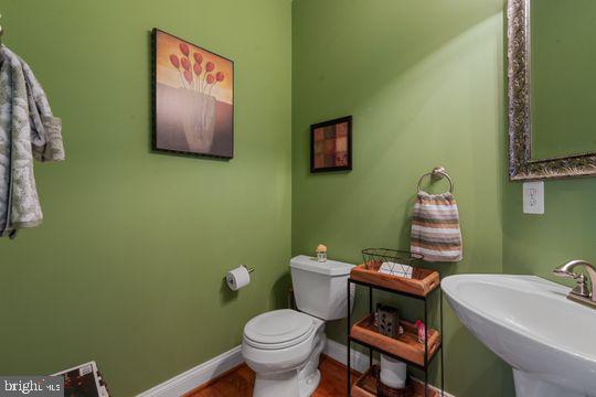 784 Olivia Way Pasadena, MD 21122 - Photo 6 of 38 a bathroom with a toilet sink and mirror