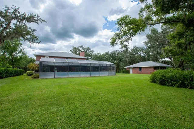 a view of house with backyard and garden