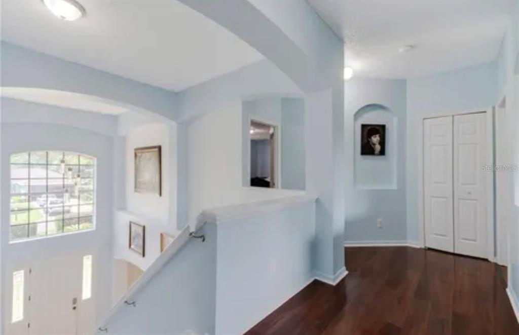 13315 Daffodil Way Astatula, FL 34705 - Photo 15 of 29 a view of a hallway with wooden floor and windows